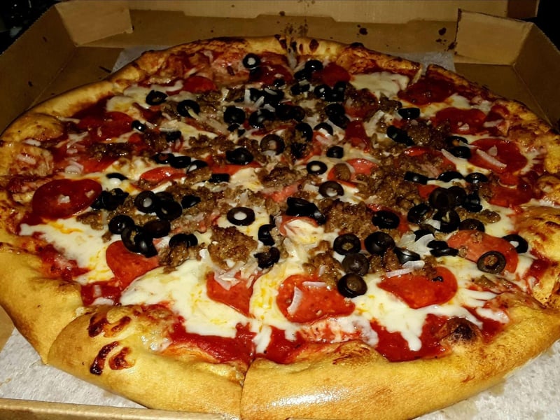 A pizza with meat and olives at Johnny McTighes in Florida