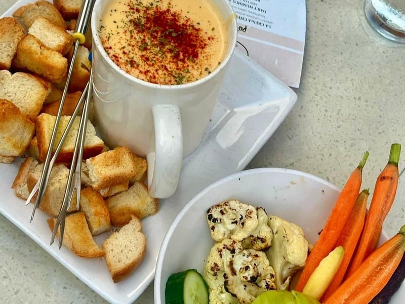 Cheese fondue with bread and vegetables