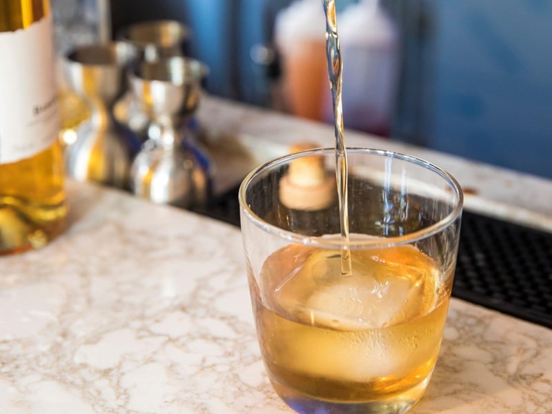 A bartendar pouring a drink at La Crema