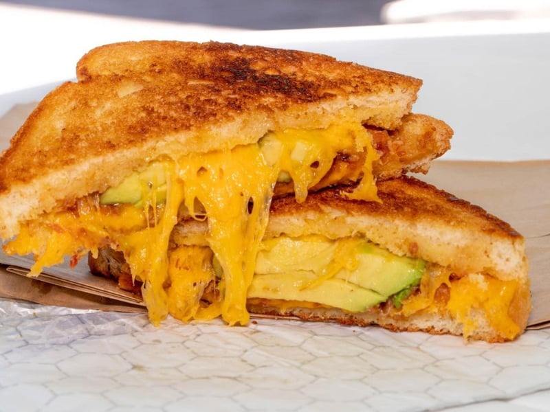A grilled cheese with bacon jam, avocado and cheddar