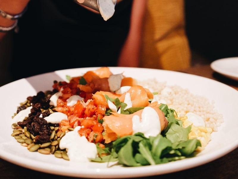 A chopped salad with smoked salmon and buttermilk basil dressing