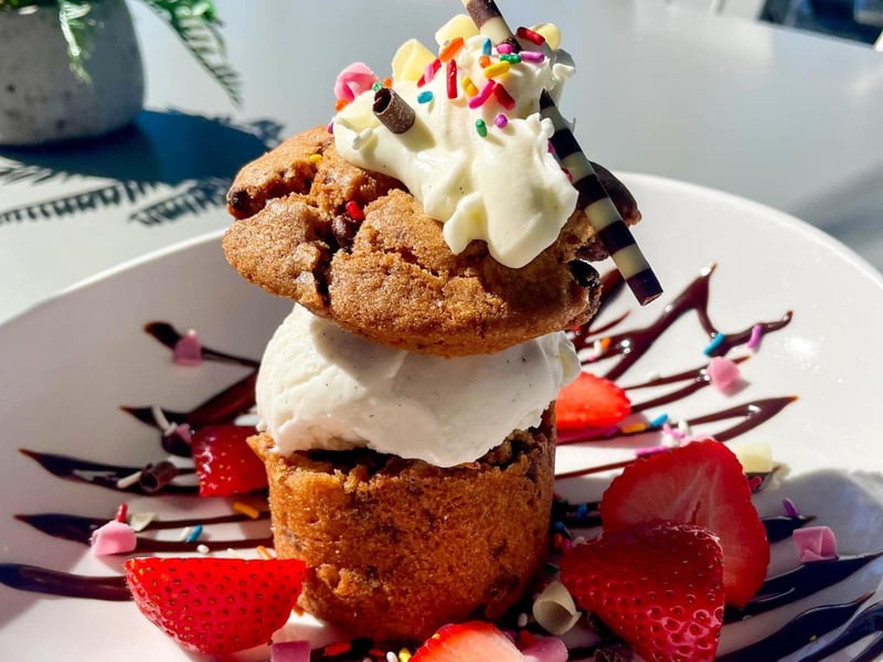 A doubledecker chocolate chip cookie with creamy vanilla ice cream