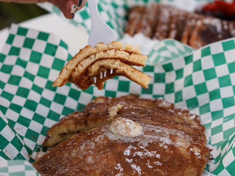 The pancake stack topped with cinnamon and powdered sugar