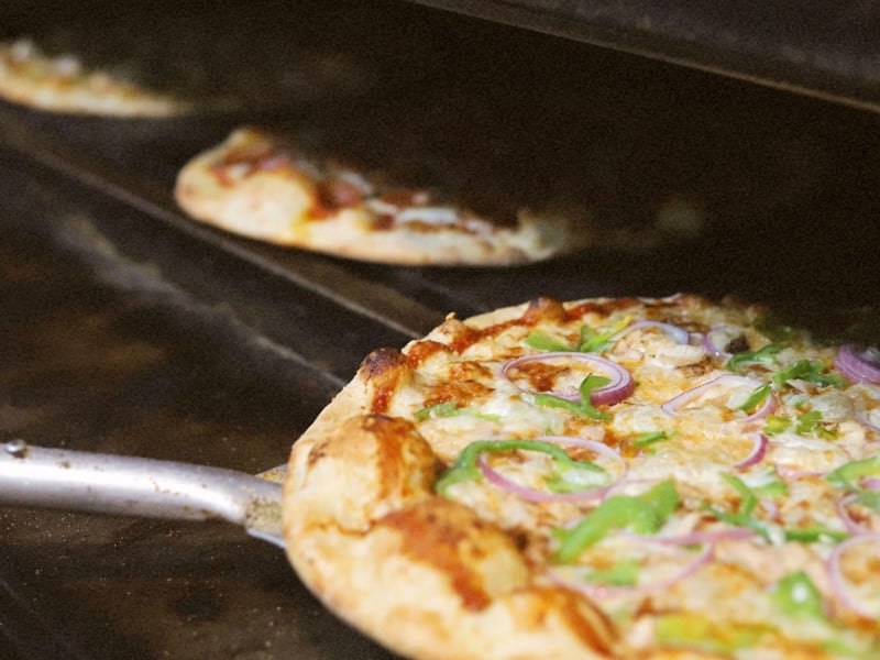 Pizzas in the oven at Pizza by the Sea, Gulf Place on Highway 30A