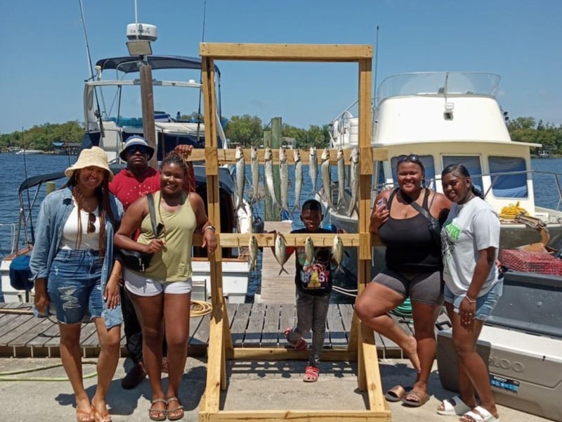 A family with their catch on the dock in Panama City Beach, Florida