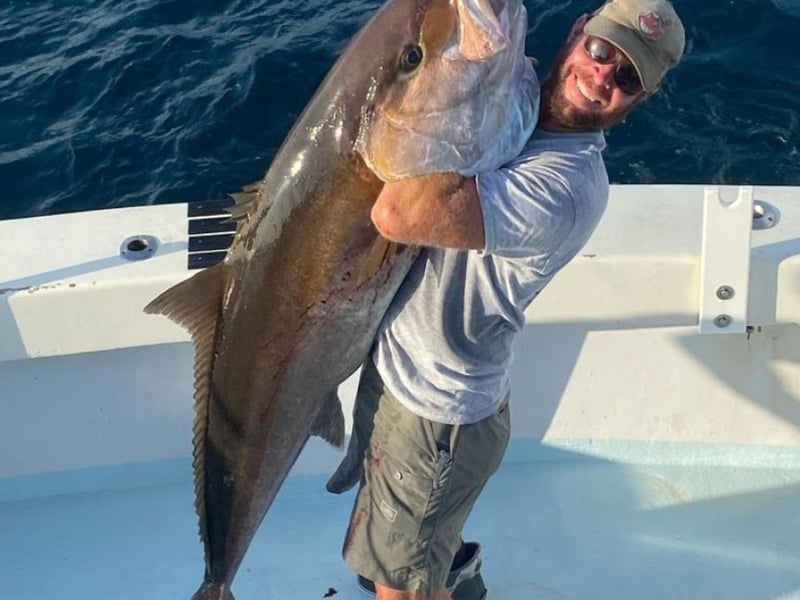 A kid showing off his catch on Vengeance Charters in Destin, Florida