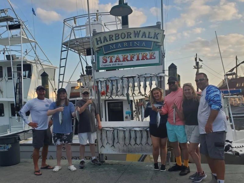 A group showing off their catch at Harborwalk Marina