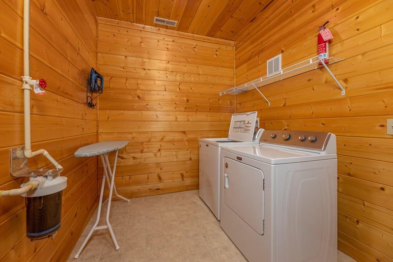 Laundry room with washer, dryer, and ironing board at Grizzlys Den, a 5 bedroom cabin rental located in Gatlinburg