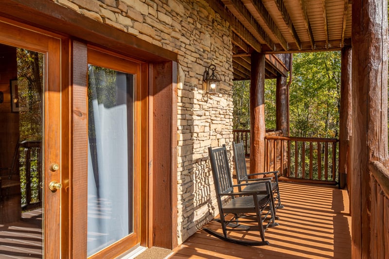 Deck with rocking chairs at Grizzlys Den, a 5 bedroom cabin rental located in Gatlinburg