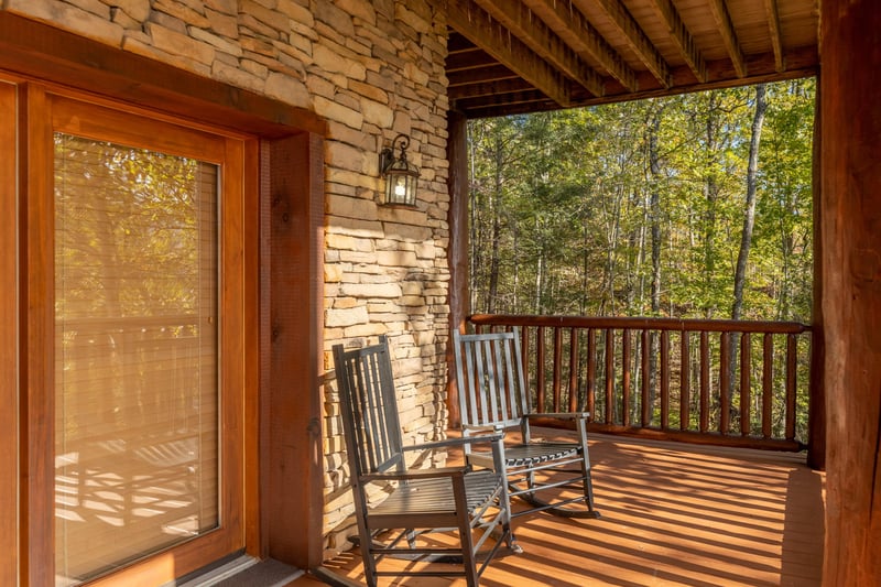 Rocking chairs on a deck at Grizzlys Den, a 5 bedroom cabin rental located in Gatlinburg