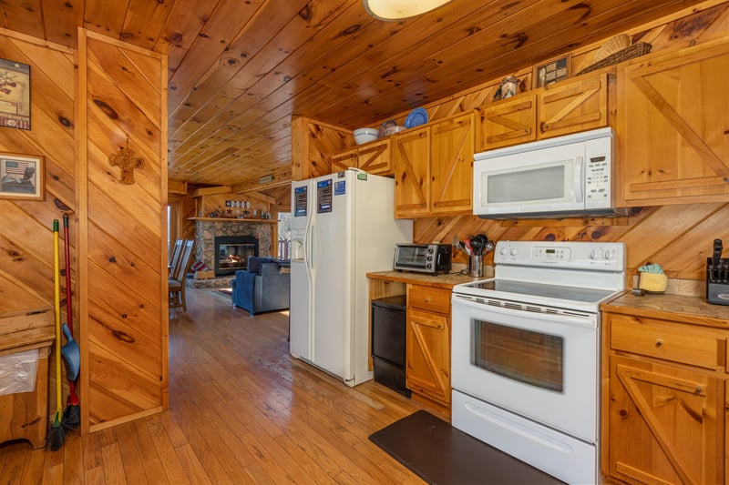 Kitchen with white appliances at Hatcher Mountain Retreat a 2 bedroom cabin rental located in Pigeon Forge