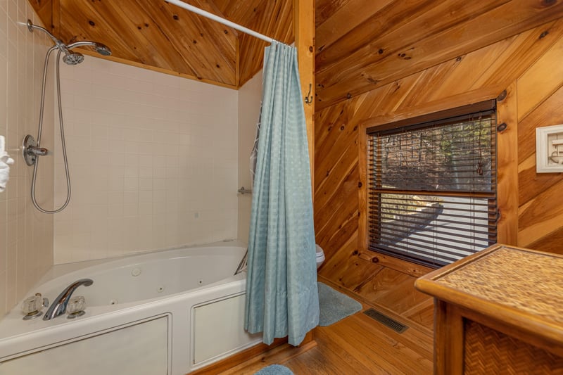 Bathroom with a shower and jacuzzi at Hatcher Mountain Retreat a 2 bedroom cabin rental located in Pigeon Forge