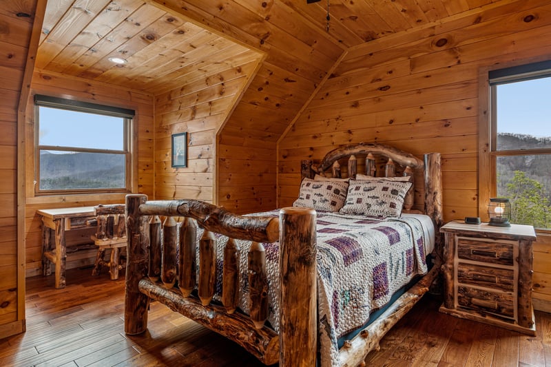 Loft king log bed with matching furniture at Four Seasons Grand, a 5 bedroom cabin rental located in Pigeon Forge