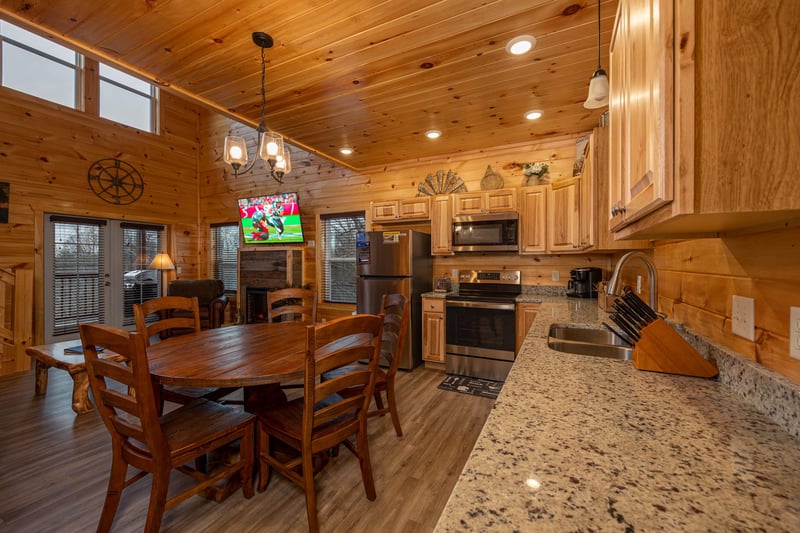 Kitchen table and appliances at Mountain Pool  Paradise, a 3 bedroom cabin rental located in Pigeon Forge