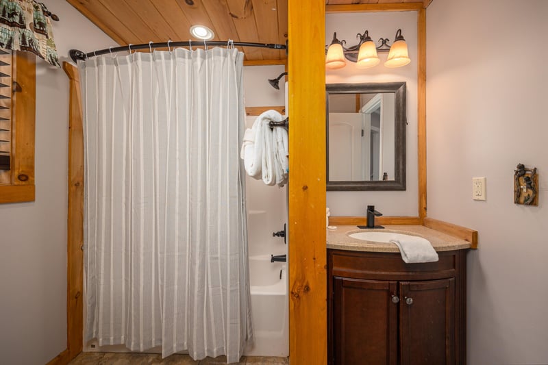 Bathroom with tubshower combo at Hoop Dreams Lodge