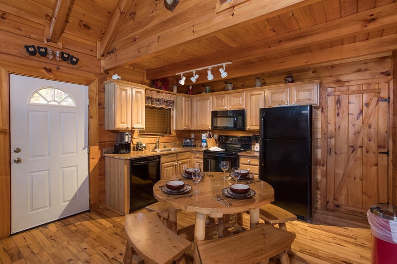 dining table with bench seating for four at always  forever a 1 bedroom cabin rental located in pigeon forge