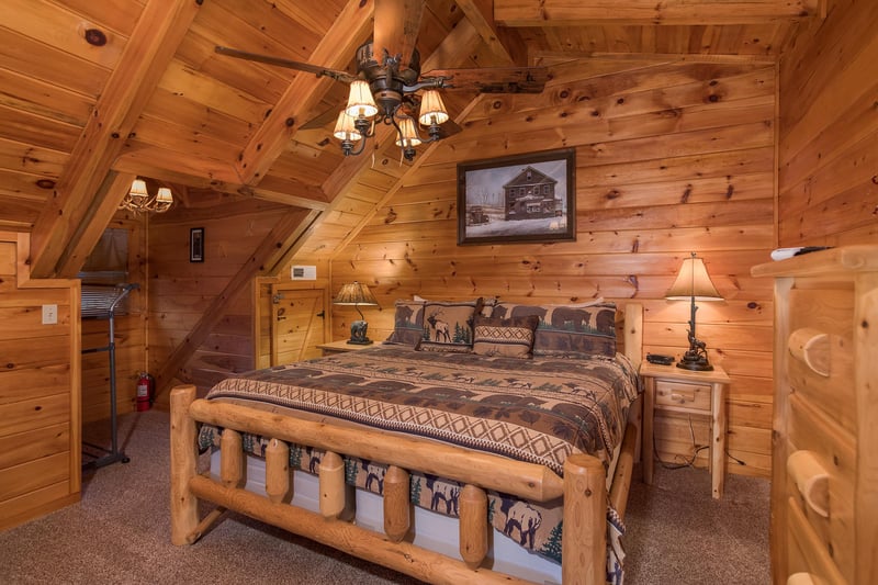 king sized log bed in a loft at always  forever a 1 bedroom cabin rental located in pigeon forge