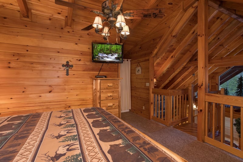 storage and television in the loft bedroom at always  forever a 1 bedroom cabin rental located in pigeon forge