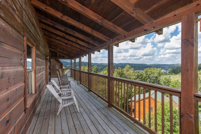 Seating and mountain views from the covered deck at Bear Country, a 3bedroom cabin rental located in Pigeon Forge