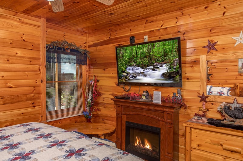 Fireplace and flat screen television in a bedroom at Bear Country, a 3bedroom cabin rental located in Pigeon Forge