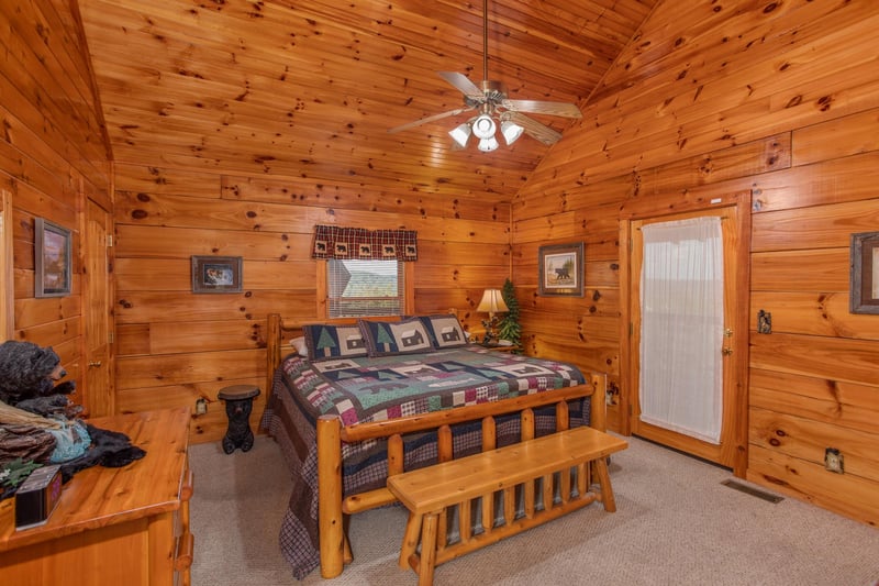 Bedroom with a log bed, bench, and vaulted ceiling at Bear Country, a 3bedroom cabin rental located in Pigeon Forge