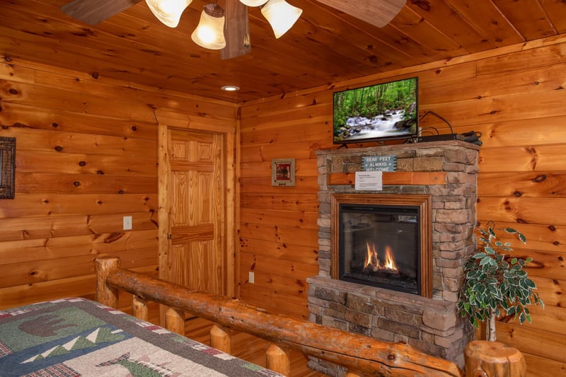 Fireplace and TV in a bedroom at 5 Star View, a 3 bedroom cabin rental located in Gatlinburg