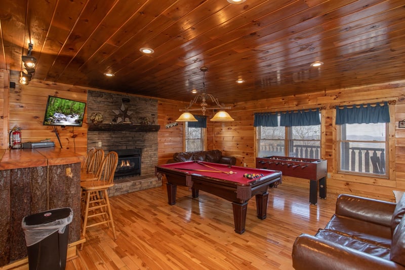 Fireplace, bar, and TV in the game room at 5 Star View, a 3 bedroom cabin rental located in Gatlinburg