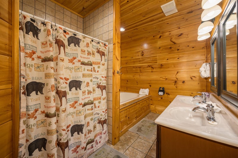 Bathroom with tub and shower at Moonbeams  Cabin Dreams, a 3 bedroom cabin rental located in Pigeon Forge