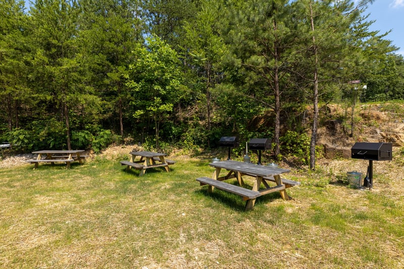 Picnic area with charcoal grill for guests at Away From it All, a 1 bedroom cabin rental located in Pigeon Forge