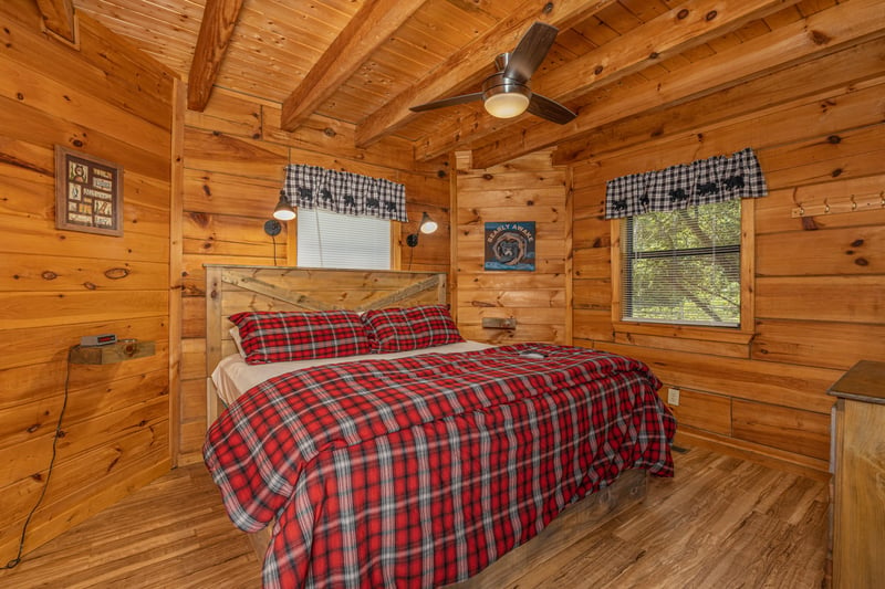 King bed and dresser in a bedroom at Walkin To Gatlinburg, a 2 bedroom cabin rental located in Gatlinburg