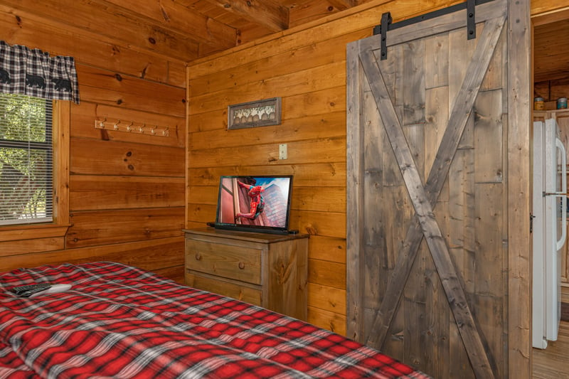 Dresser and TV in a bedroom at Walkin To Gatlinburg, a 2 bedroom cabin rental located in Gatlinburg