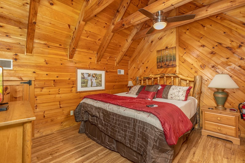 Loft bedroom with a night stand and lamp Walkin To Gatlinburg, a 2 bedroom cabin rental located in Gatlinburg