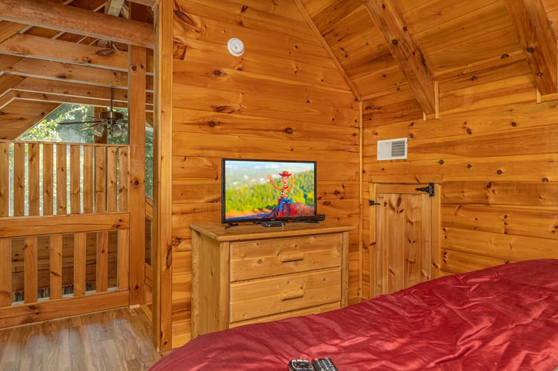 Bedroom with a dresser and TV at Walkin To Gatlinburg, a 2 bedroom cabin rental located in Gatlinburg