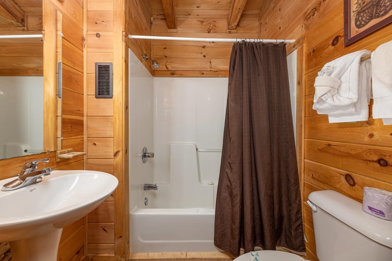 Bathroom with a tub and shower at Walkin to Gatlinburg, a 2 bedroom cabin rental located in Gatlinburg