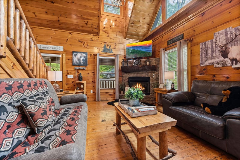 Living room with fireplace and TV at Honey Bear Haven, a 1 bedroom cabin rental located in Pigeon Forge