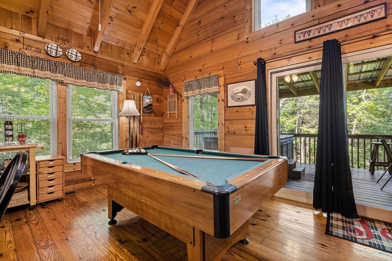 Pool table in the great room with deck access at Cloud 9, a 1bedroom cabin rental located in Pigeon Forge