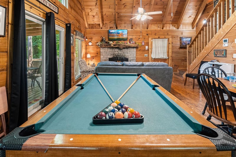 Pool table in the great room with deck access at Cloud 9, a 1bedroom cabin rental located in Pigeon Forge