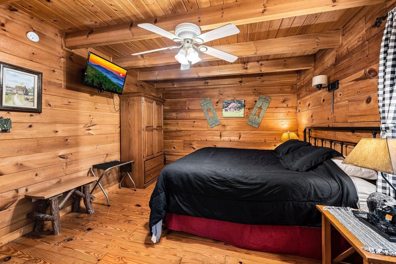 Bedroom with a queensized bed and television at Cloud 9, a 1bedroom cabin rental located in Pigeon Forge