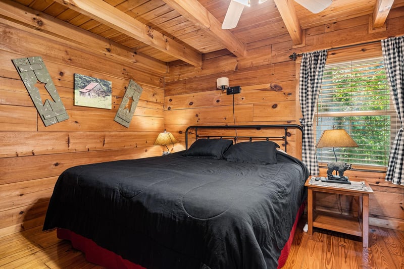 Bedroom with a queensized bed and television at Cloud 9, a 1bedroom cabin rental located in Pigeon Forge