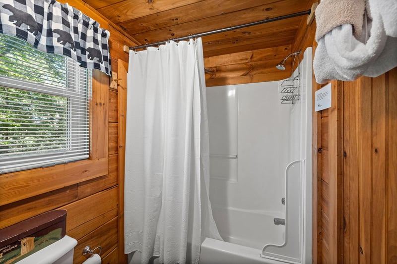 Bathroom with a tub and shower at Cloud 9, a 1bedroom cabin rental located in Pigeon Forge