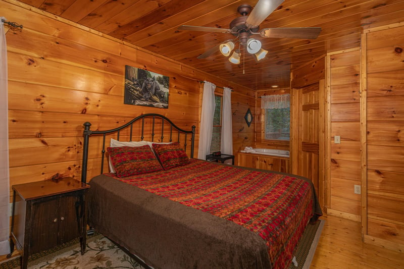 Bedroom with a king bed and jacuzzi at Firefly Ridge, a 2 bedroom cabin rental located in Pigeon Forge