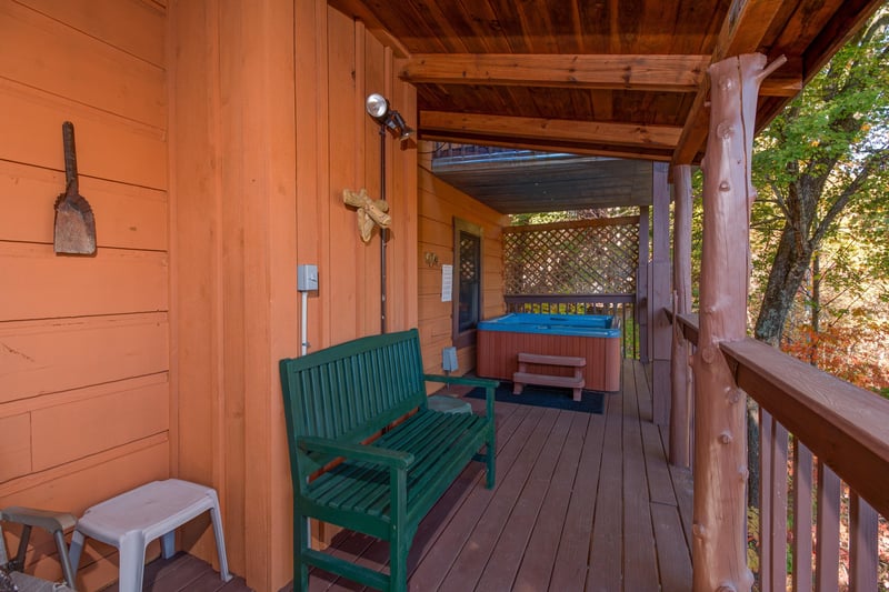 Deck with a bench and hot tub at Hawks Nest, a 1 bedroom cabin rental located in Pigeon Forge