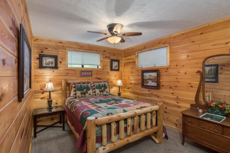 Bedroom with a log bed, two lamps, and dresser at Birds Eye View, a 2bedroom cabin rental located in Gatlinburg