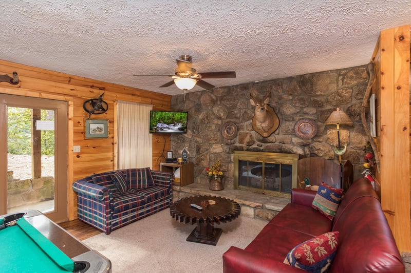 Fireplace and TV in a living room at Birds Eye View, a 2bedroom cabin rental located in Gatlinburg