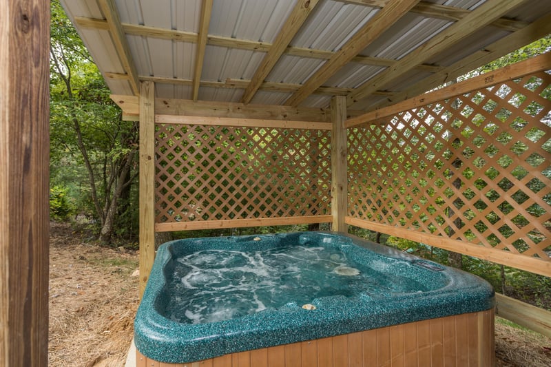 Hot tub on a covered deck at Birds Eye View, a 2bedroom cabin rental located in Gatlinburg