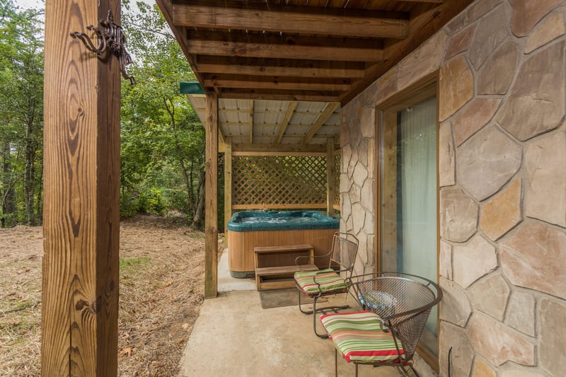 Patio with chairs and hot tub at Birds Eye View, a 2bedroom cabin rental located in Gatlinburg