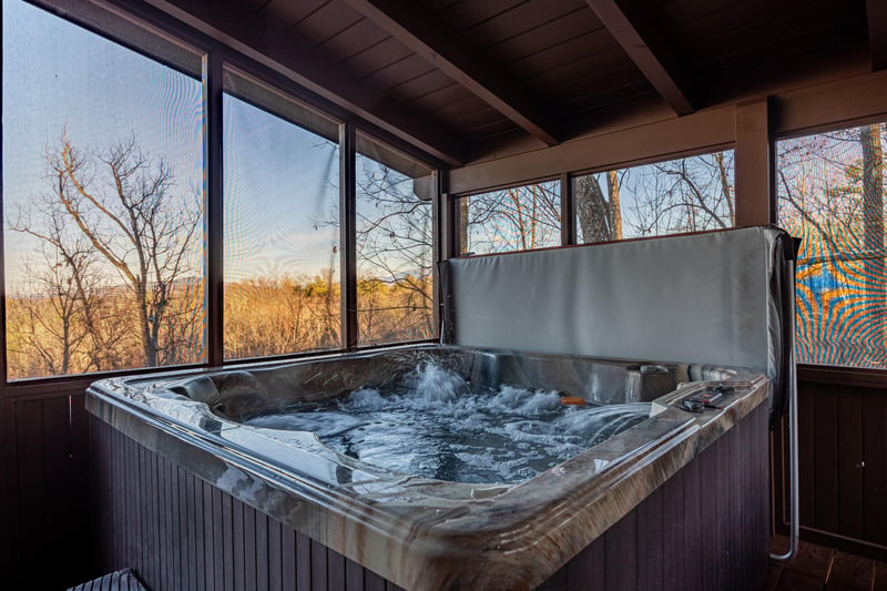 Hot tub on screenedin porch at Gone To Therapy, a 2 bedroom cabin rental located in Gatlinburg