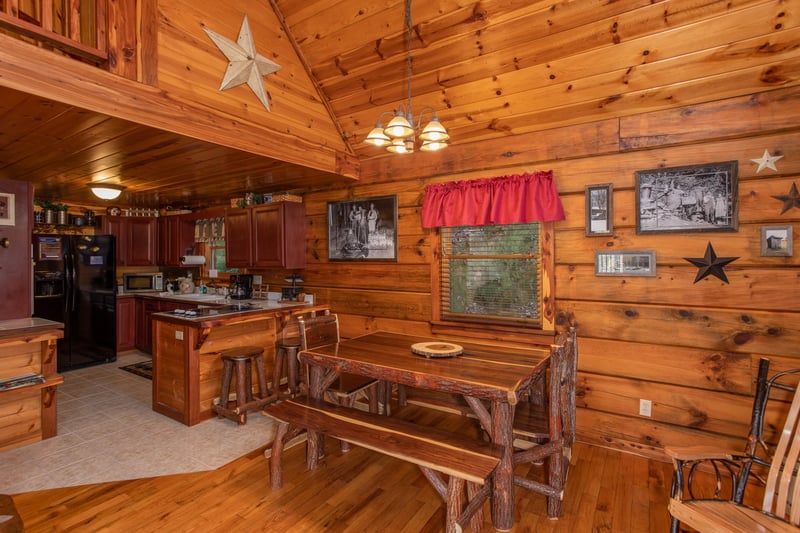 Picnic style dining table in the dining room at Moonshiners Ridge, a 1bedroom cabin rental located in Pigeon Forge