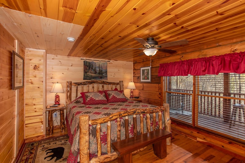 Bedroom with a log bed, night stands, and lamps at Moonshiners Ridge, a 1bedroom cabin rental located in Pigeon Forge