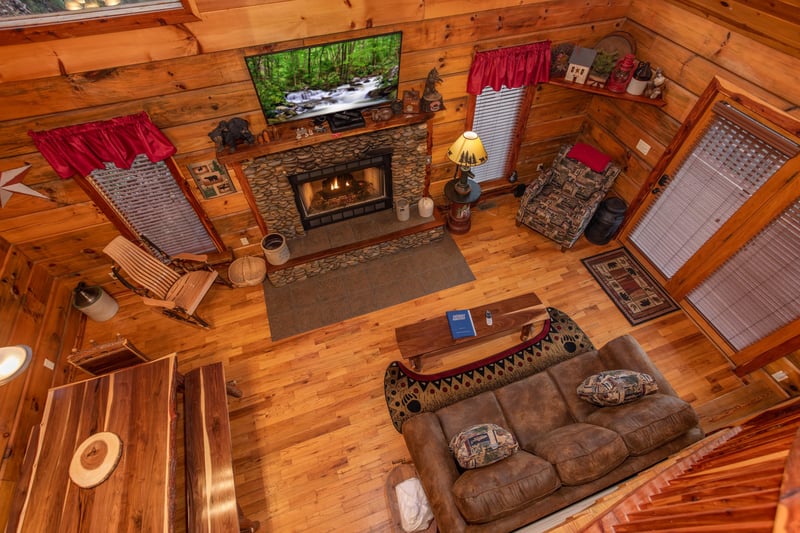 Looking down at the living room at Moonshiners Ridge, a 1bedroom cabin rental located in Pigeon Forge